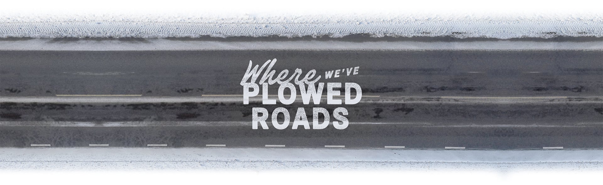 Bird's-eye view of two snowplows branded with Domino's 'Plowing for Pizza' tagline, moving across a road that has been cleard of snow.